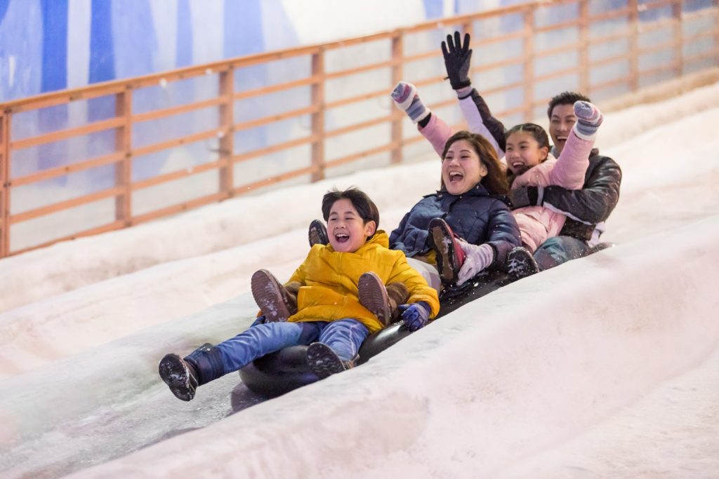 Enjoy the best winter activities like sliding down a 2m high slope at Snow City.