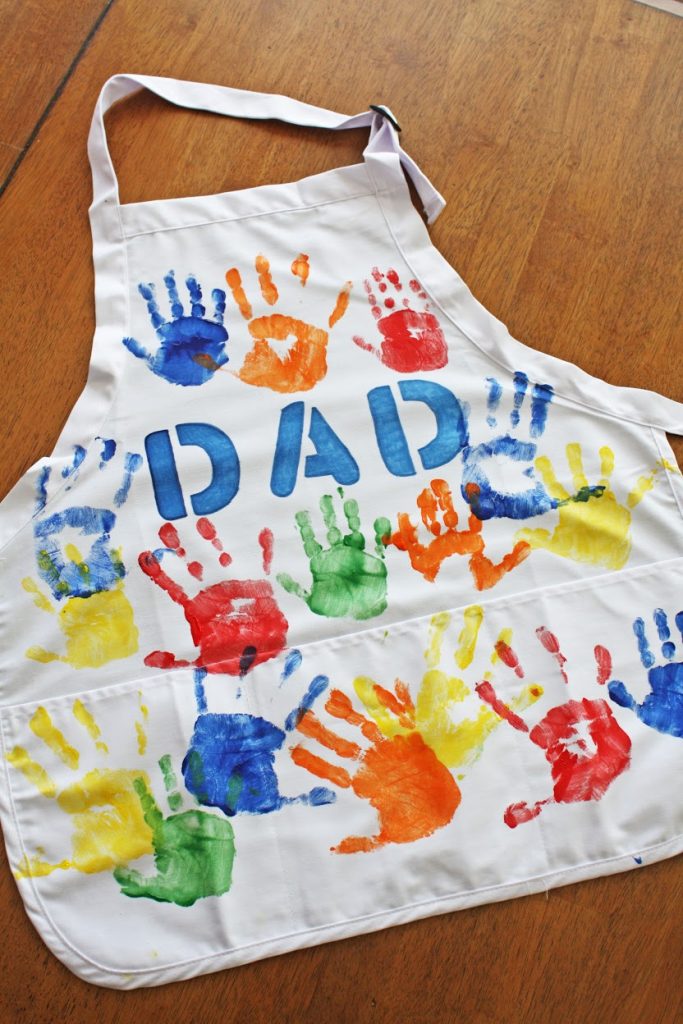 For dads who love to cook, decorate an apron with “Dad” and paint on your little ones’ hands.