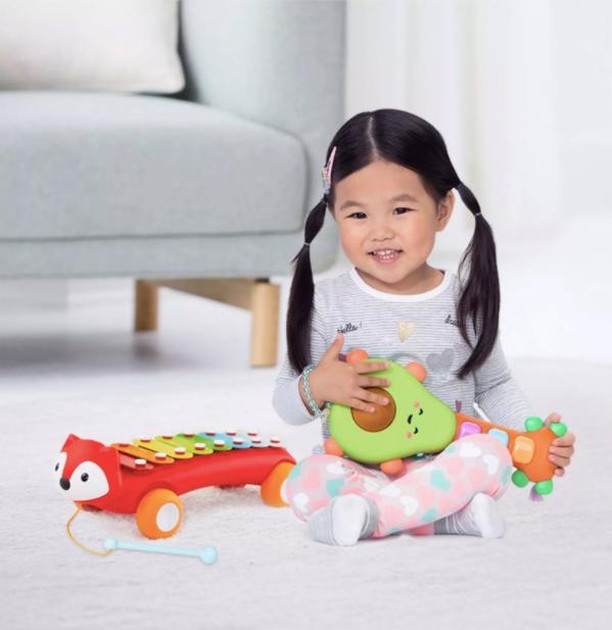 smart toys: asian girl playing with musical toys