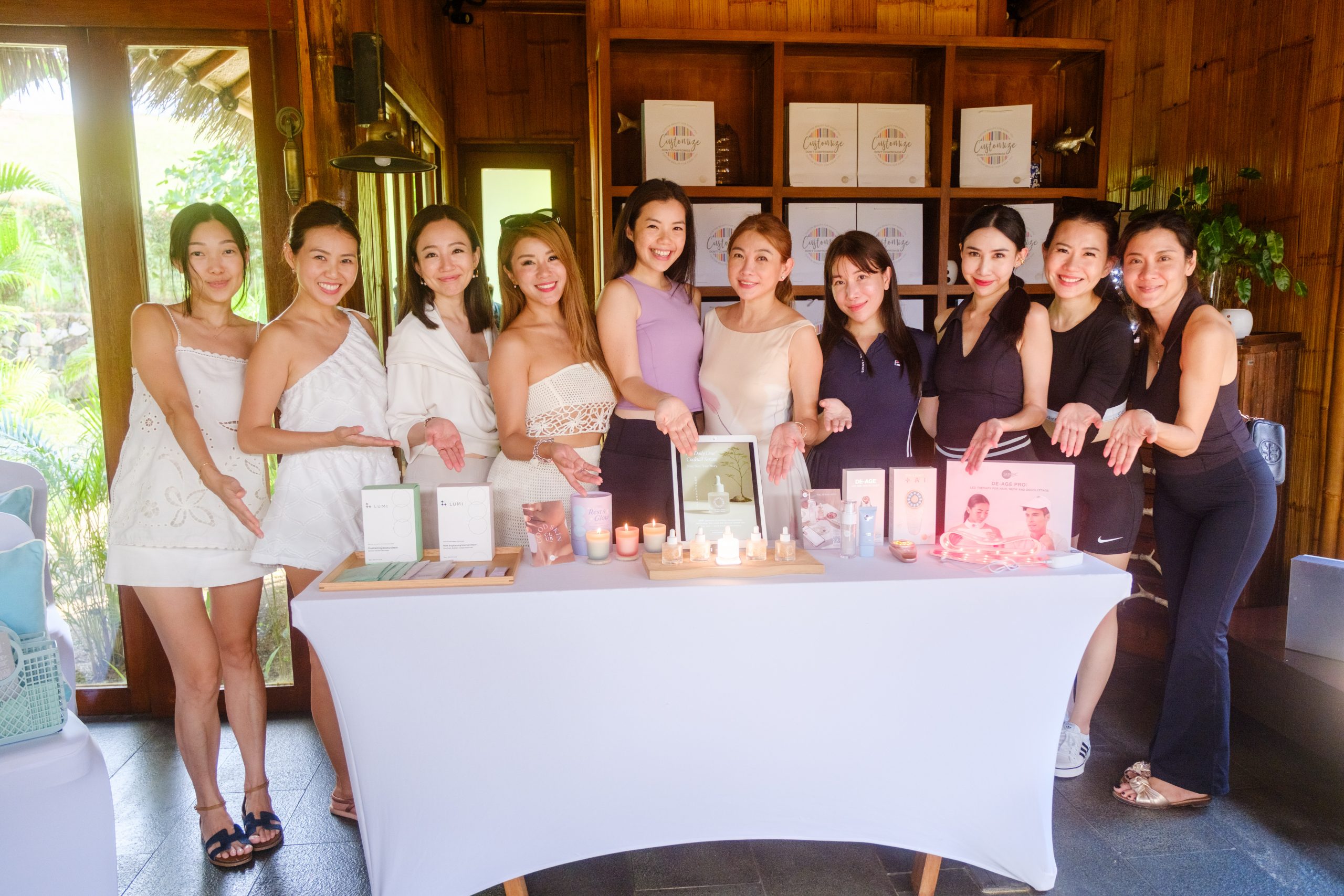 Our guests posing with Skin Inc's product range, which includes candles, custom serums, and skincare devices for holistic wellness.